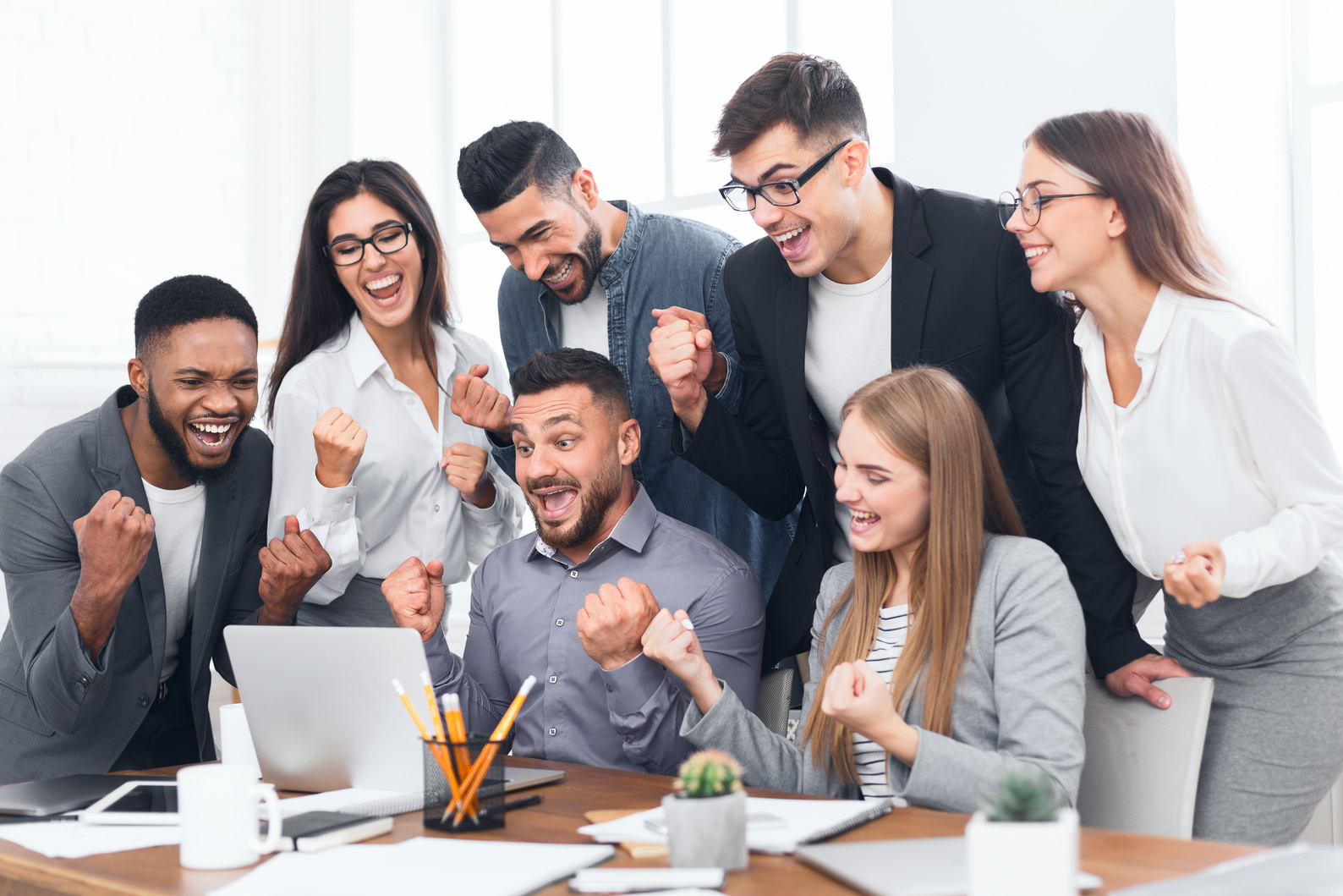 Entrepreneurs team celebrating victory in office